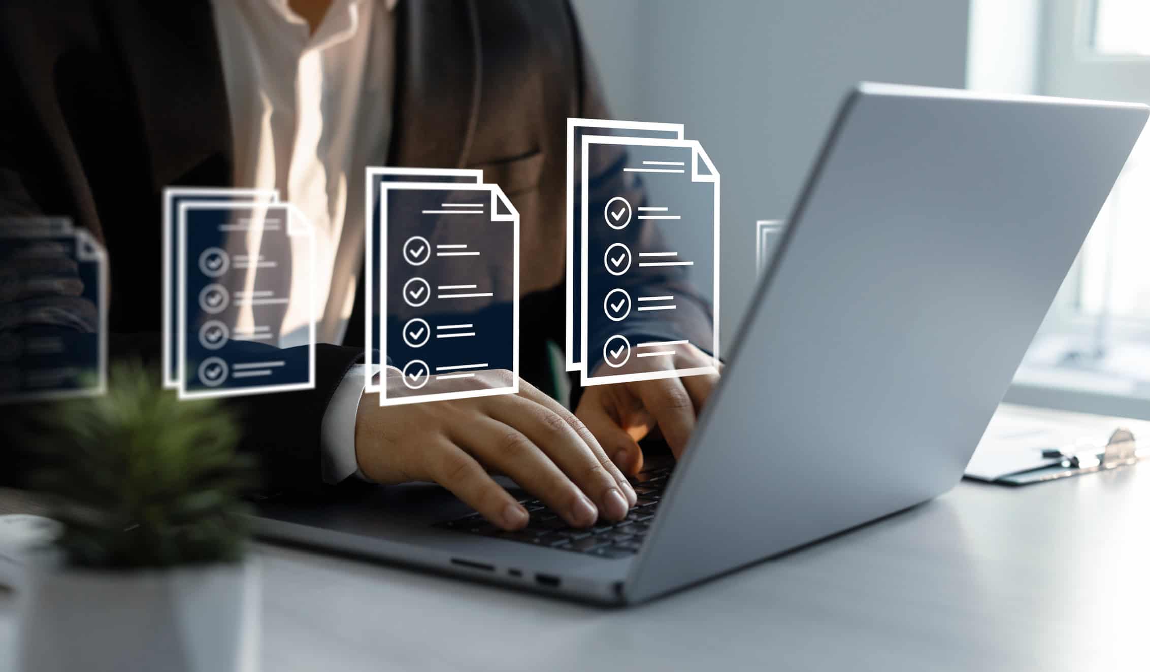 A closeup of a person on a laptop with document icons overlayed on the photo