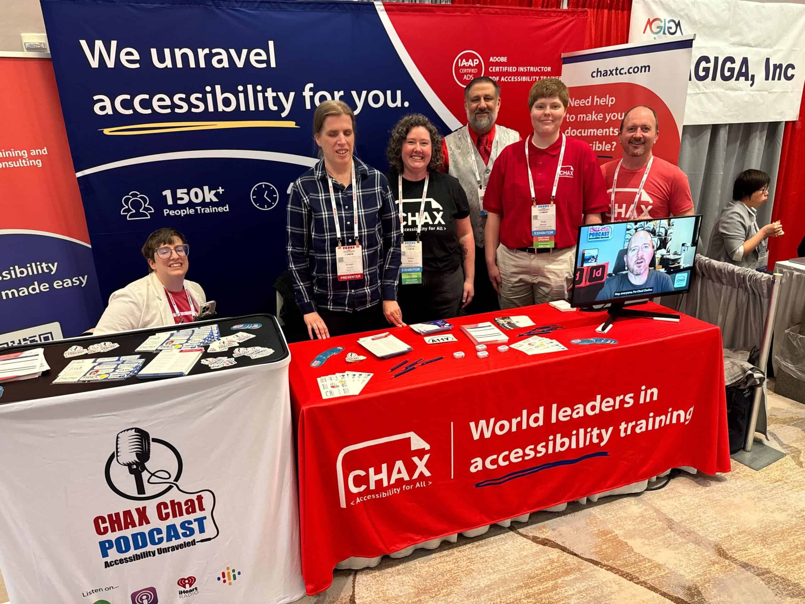 Six members of the Chax team standing behind their booth at a conference